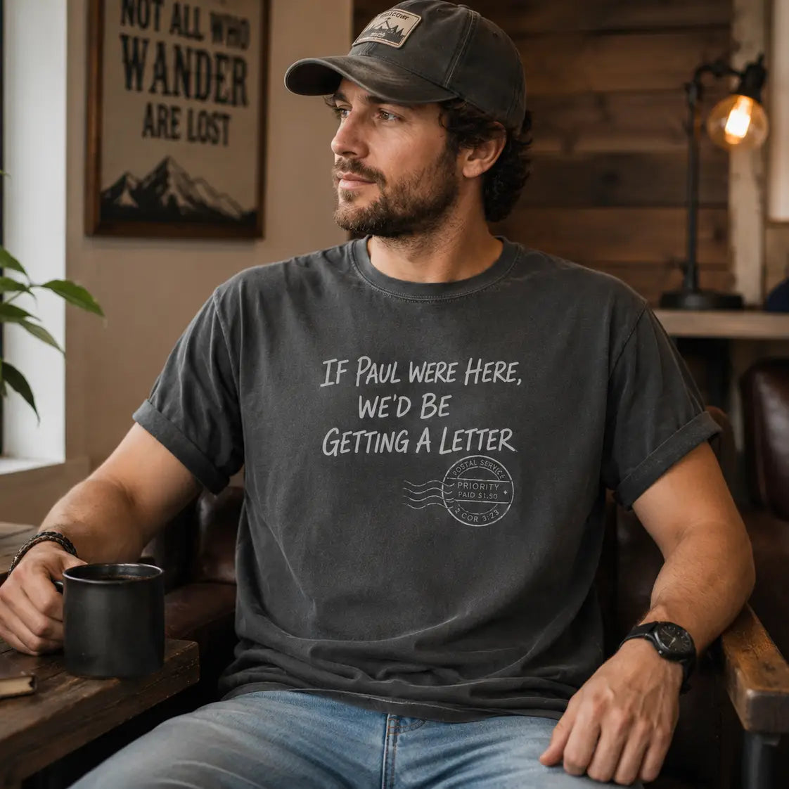 Man wearing a faith-inspired graphic tee that reads If Paul Were Here, We'd Be Getting A Letter