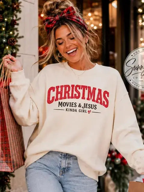 Woman wearing Christmas Movies and Jesus Kinda Girl cream sweatshirt while Christmas shopping