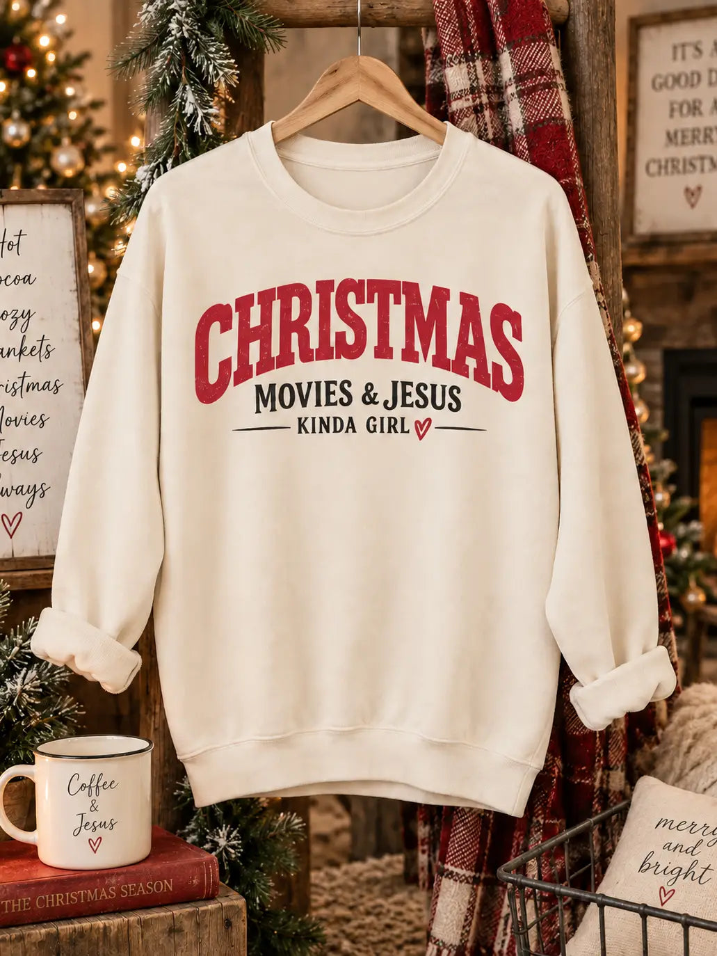 Christmas Movies and Jesus Kinda Girl cream graphic sweatshirt on hanger with holiday decor