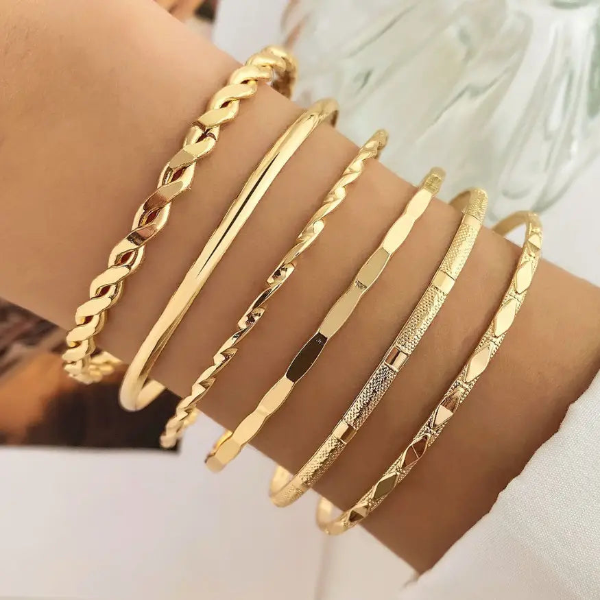 Gold Layered Bangle Set stacked on wrist showing mixed textures