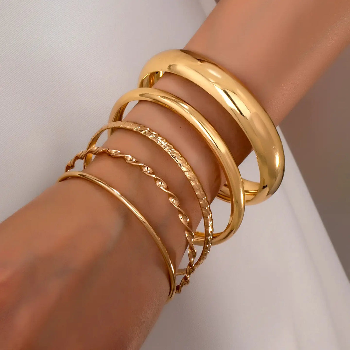 Gold Textured Bangle Set stacked on wrist
